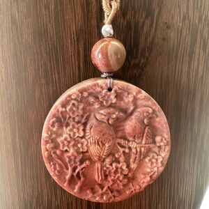 Coral Fossil Carved Round Bird Pendant Necklace on Tan Adjustable Rope